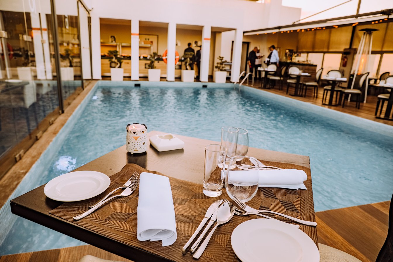 Brown Wooden Table Beside Pool